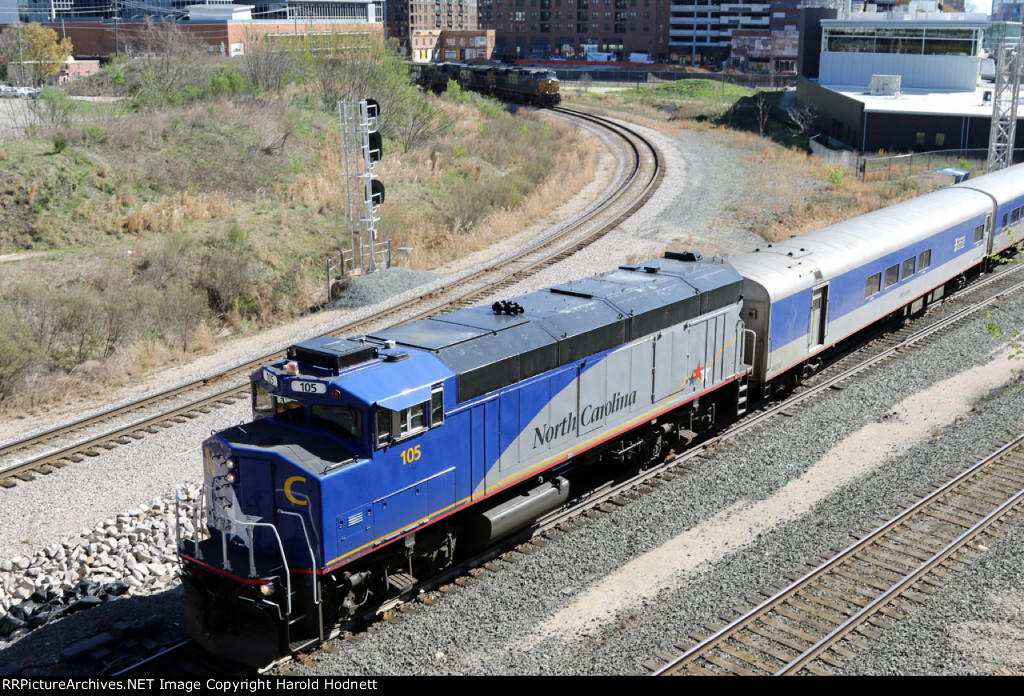 RNCX 105 leads train P075-08 away from RUS as CSX train L619 approaches